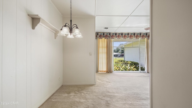 interior space featuring a notable chandelier, carpet floors, and crown molding