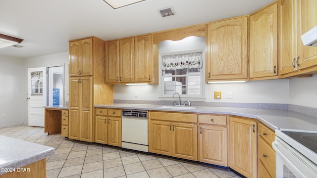 kitchen featuring sink, white dishwasher, light tile patterned floors, and light brown cabinets