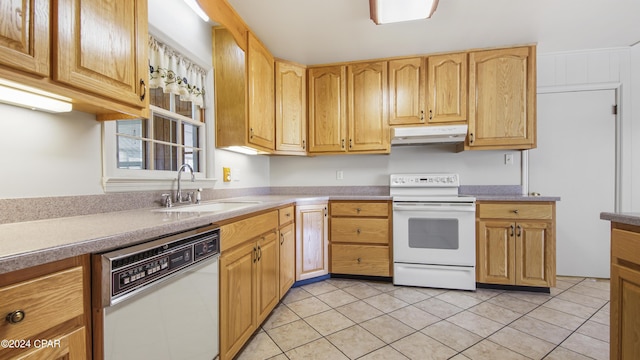 kitchen featuring light tile patterned flooring, white appliances, and sink