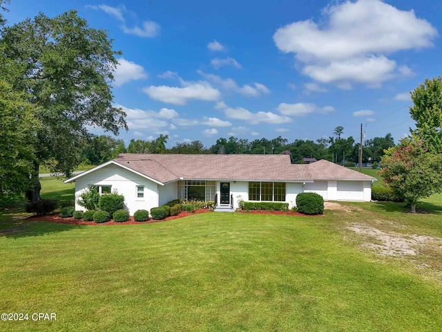 ranch-style home with a front lawn