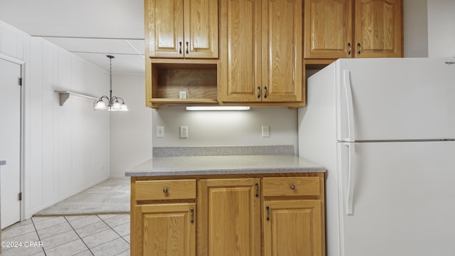 kitchen featuring a chandelier, light tile patterned floors, white fridge, and hanging light fixtures