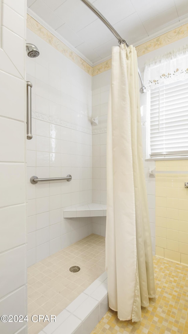 bathroom featuring a shower with shower curtain and ornamental molding