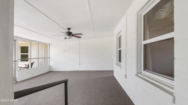 unfurnished sunroom featuring ceiling fan