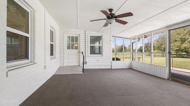 unfurnished sunroom featuring ceiling fan and lofted ceiling