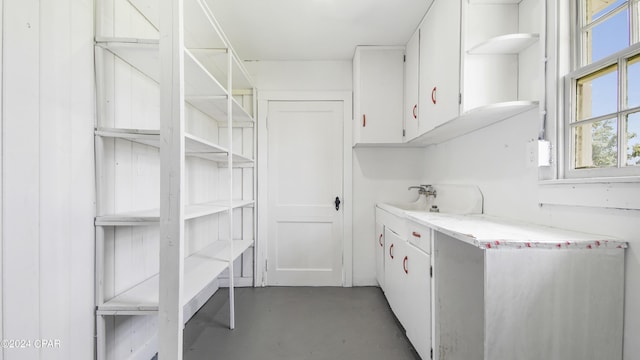 interior space with white cabinets and sink