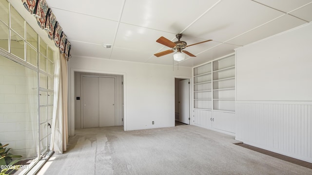 unfurnished bedroom featuring ceiling fan and light carpet