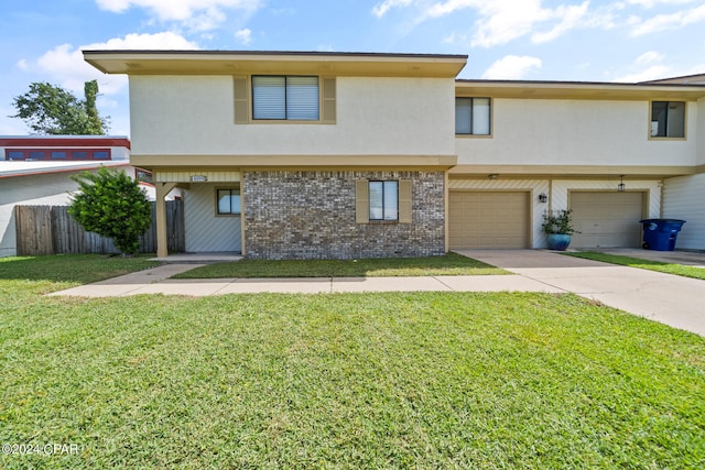 view of property featuring a garage and a front yard