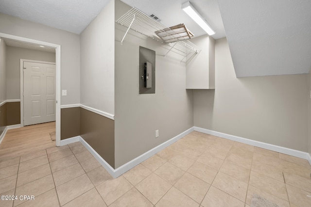 interior space with a textured ceiling and light tile patterned floors