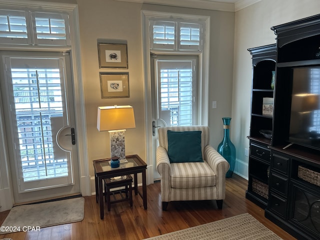 sitting room featuring crown molding and dark hardwood / wood-style floors