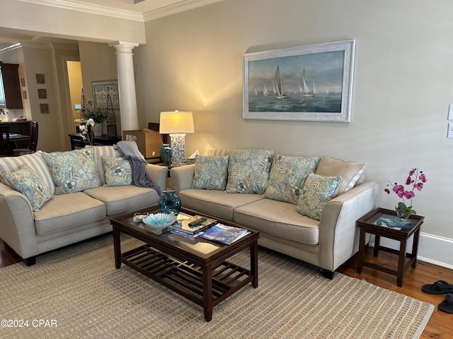 living room with ornamental molding, light wood-type flooring, and ornate columns