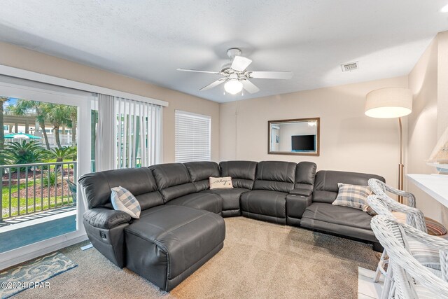 living room with ceiling fan and light carpet