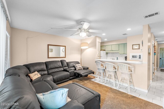 living room with light tile patterned floors and ceiling fan