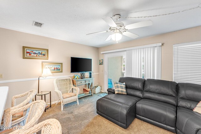 living room with carpet flooring and ceiling fan