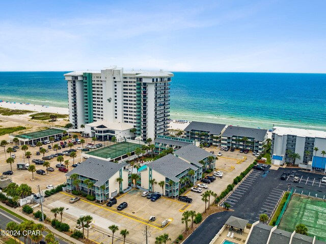 drone / aerial view featuring a beach view and a water view