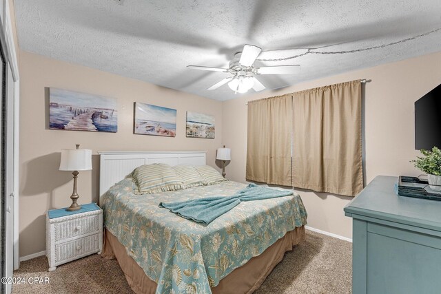 bedroom featuring ceiling fan, a textured ceiling, and carpet flooring