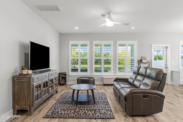 living room with light hardwood / wood-style floors and ceiling fan