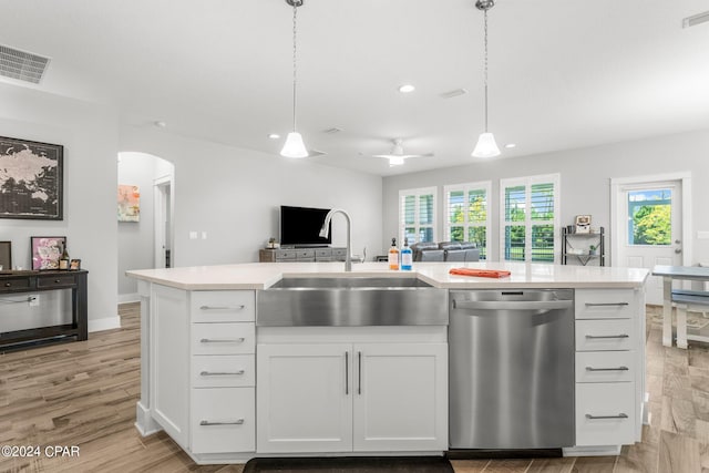 kitchen with white cabinetry, sink, stainless steel dishwasher, and decorative light fixtures