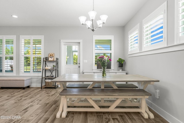 dining area with a chandelier and wood-type flooring