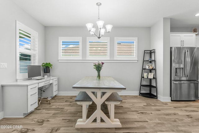 dining space featuring a chandelier and light hardwood / wood-style floors