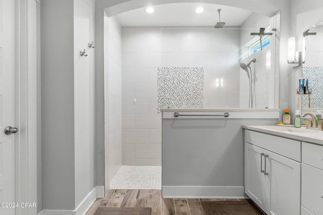 bathroom featuring vanity and tiled shower