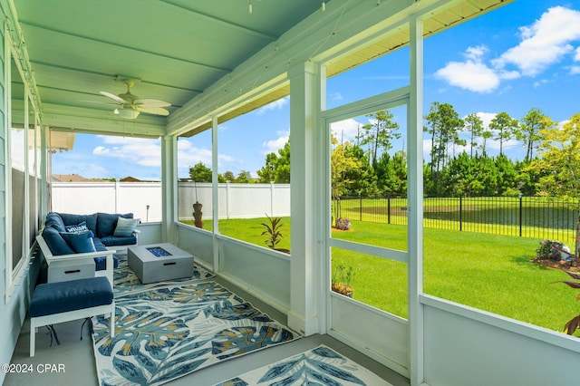 sunroom featuring ceiling fan