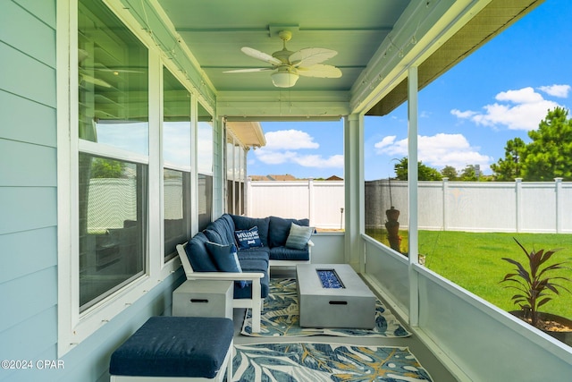 sunroom featuring ceiling fan