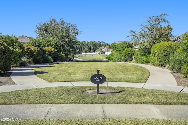 view of home's community featuring a lawn