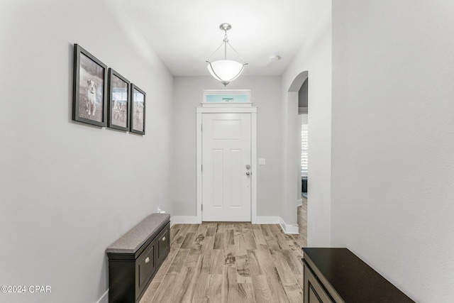 doorway to outside with light wood-type flooring