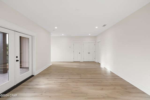 unfurnished room with light wood finished floors, recessed lighting, visible vents, and french doors