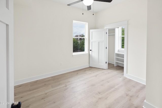 unfurnished bedroom with ceiling fan, wood finished floors, and baseboards