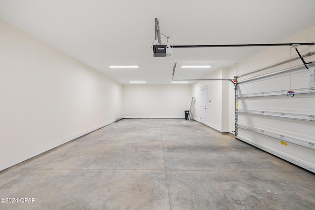 garage with baseboards and a garage door opener