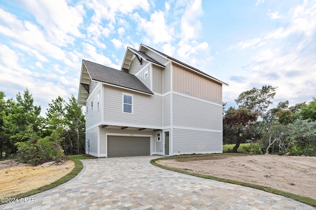 view of side of home featuring a garage