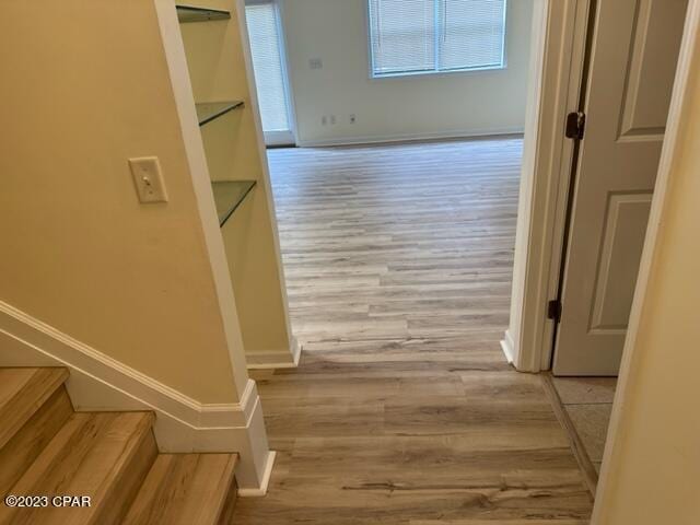 corridor with light hardwood / wood-style floors