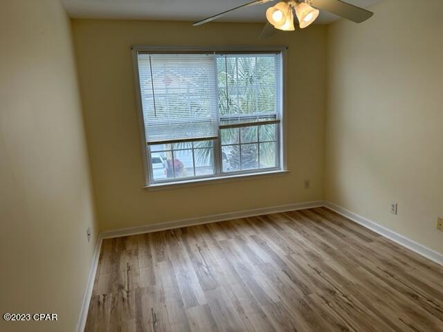 spare room with ceiling fan and light wood-type flooring