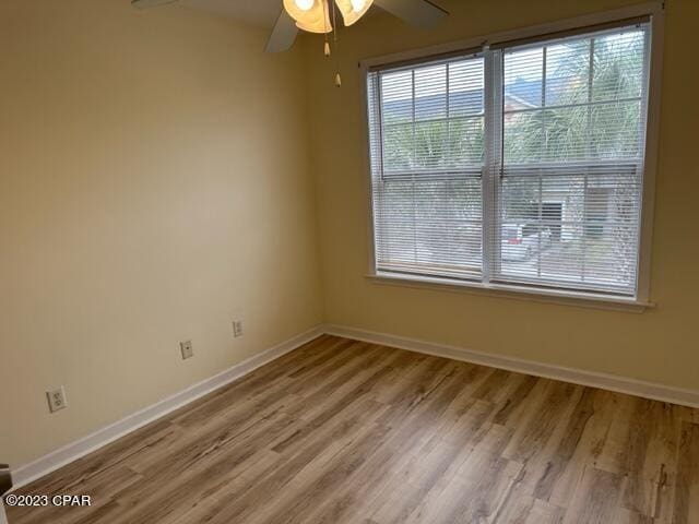 spare room featuring hardwood / wood-style flooring and ceiling fan