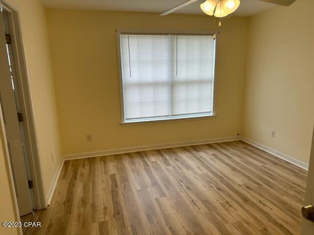 spare room with ceiling fan and light wood-type flooring