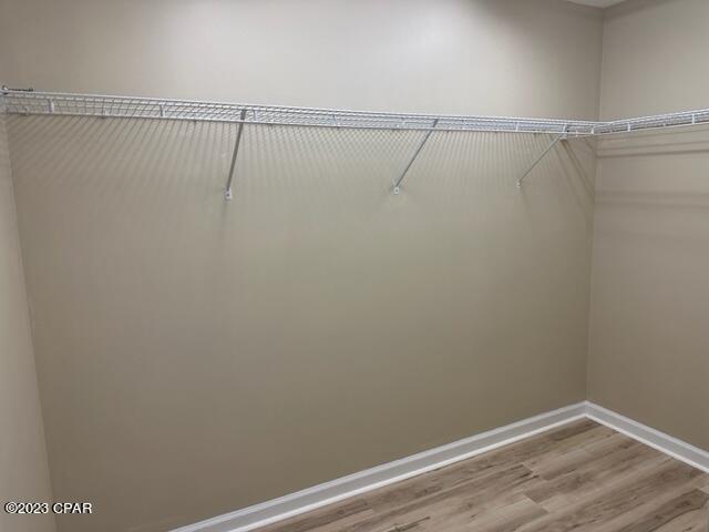 spacious closet featuring hardwood / wood-style flooring