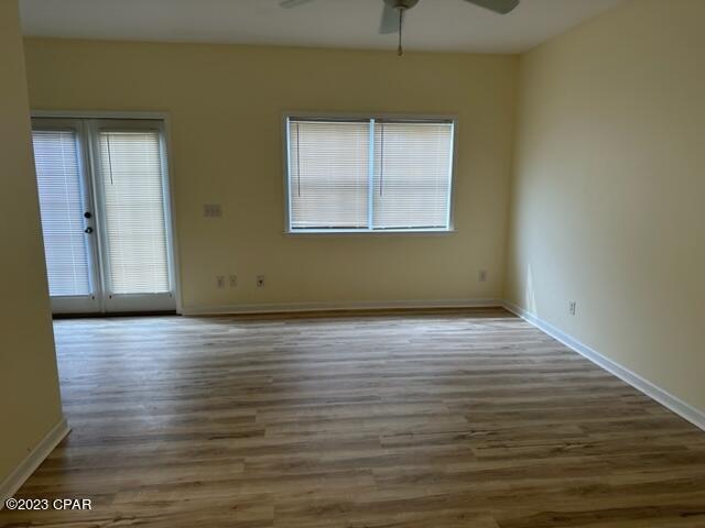 unfurnished room featuring dark wood-type flooring, ceiling fan, and french doors