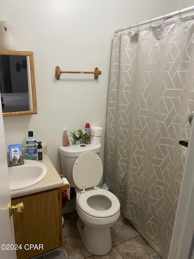 bathroom with vanity, toilet, and tile patterned floors