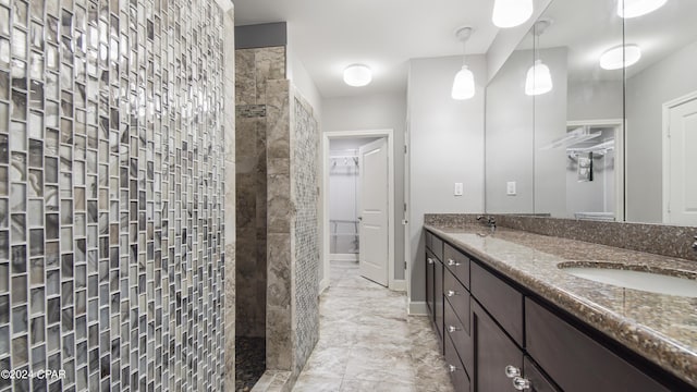 bathroom featuring vanity and a tile shower