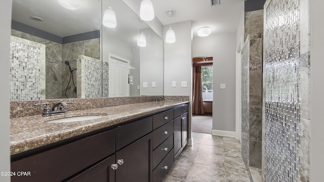 bathroom with vanity and a tile shower