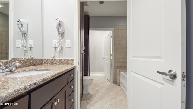 full bathroom featuring tile patterned flooring, vanity, toilet, and tiled shower / bath combo