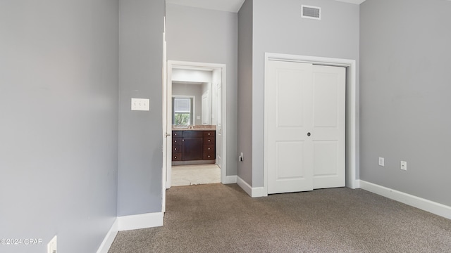 hall featuring carpet flooring