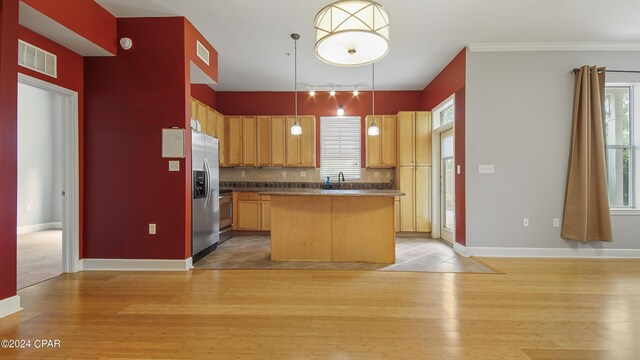 kitchen featuring a center island, light hardwood / wood-style floors, and hanging light fixtures