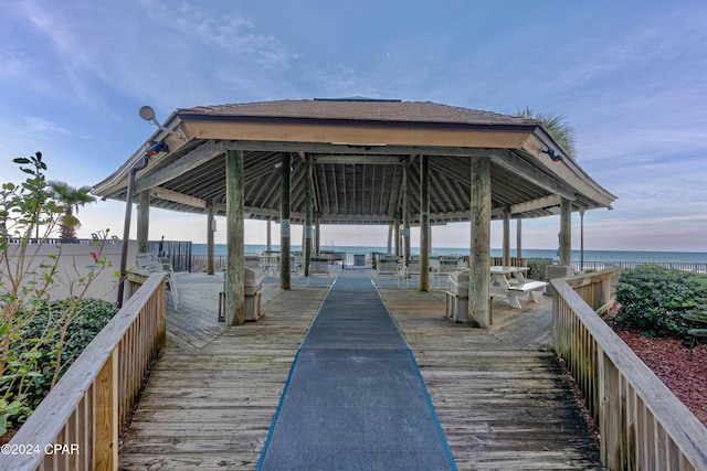 surrounding community with a water view and a gazebo