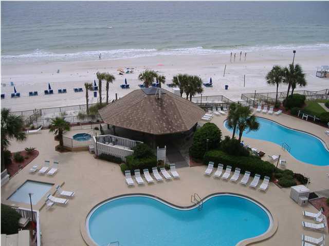 view of pool with a water view, a patio area, and a view of the beach