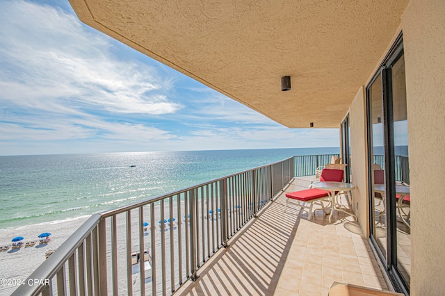 balcony with a view of the beach and a water view