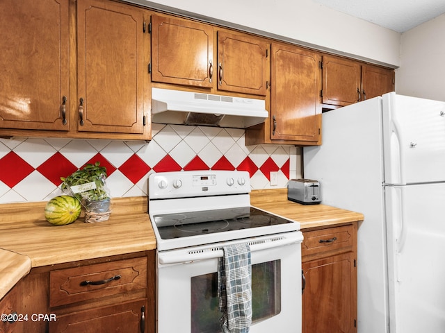 kitchen featuring tasteful backsplash and white appliances