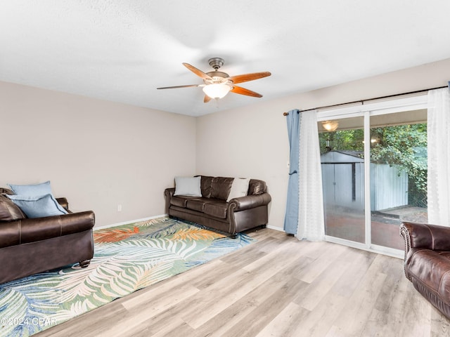 living room with light wood-type flooring and ceiling fan