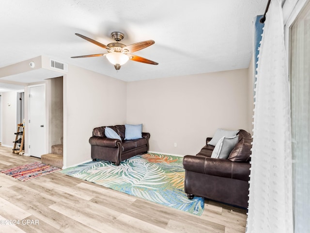 living room featuring ceiling fan and light wood-type flooring